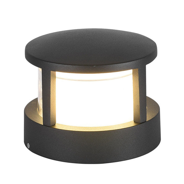 Close-up van de ronde donkergrijze lamp met plat dak, drie stijlen en een gloeiend matwit scherm. 12