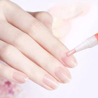 Close-up van een hand met roze nagels terwijl een pen met penseel olie op de nagel aanbrengt 11