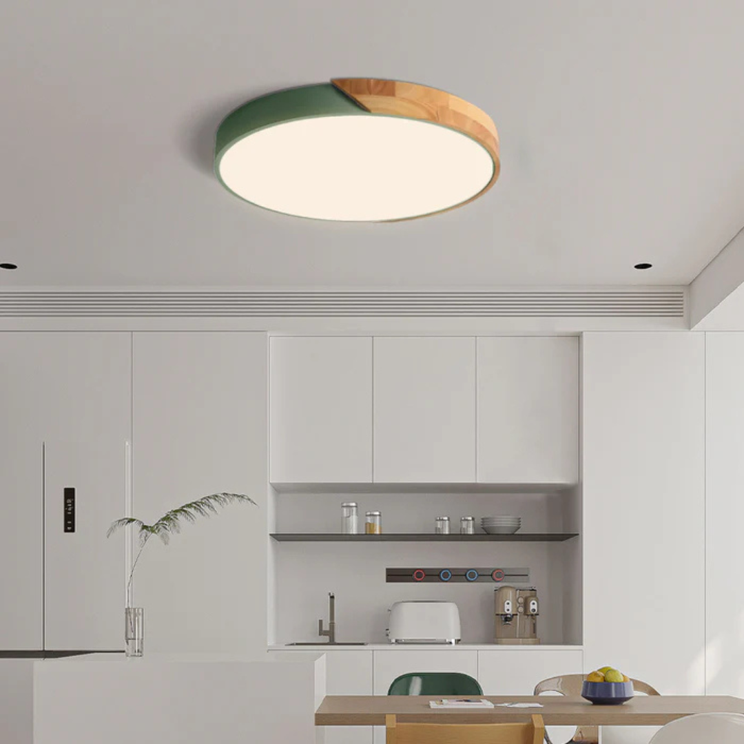 Ronde plafondlamp met groene rand en houten deel boven een witte moderne keuken 3