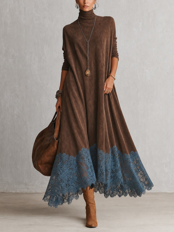 Model loopt in bruine jurk met col en blauwe kanten zoom, met tas en laarzen 1