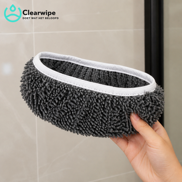 Hand houdt een grijze chenille dweilpad met witte elastische rand vast voor een tegelwand, de opening naar boven gericht. 4
