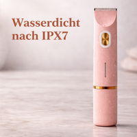 Roze trimmer met waterdruppels staat rechtop op een marmeren ondergrond en toont de waterdichte uitvoering. 11