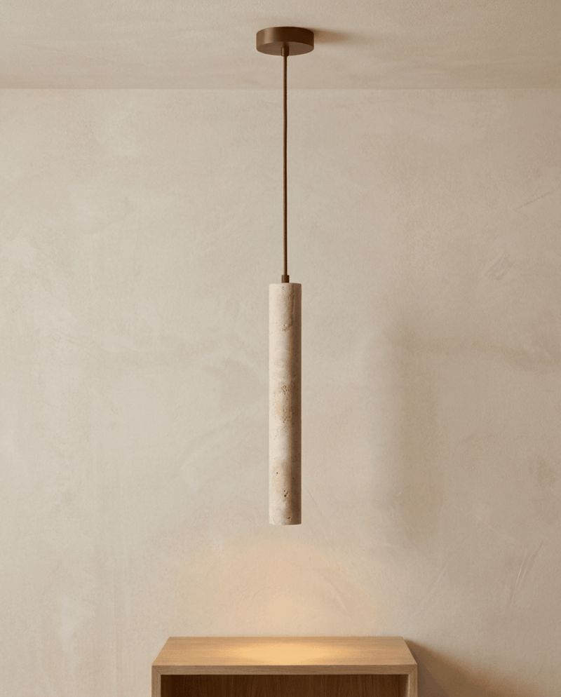 Travertijnen hanglamp met messingkleurig plafondplaatje en dun snoer, brandend boven een houten kastje 6