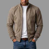 Model draagt de taupekleurige jack open over een wit T-shirt, handen in de zakken van de spijkerbroek. 2