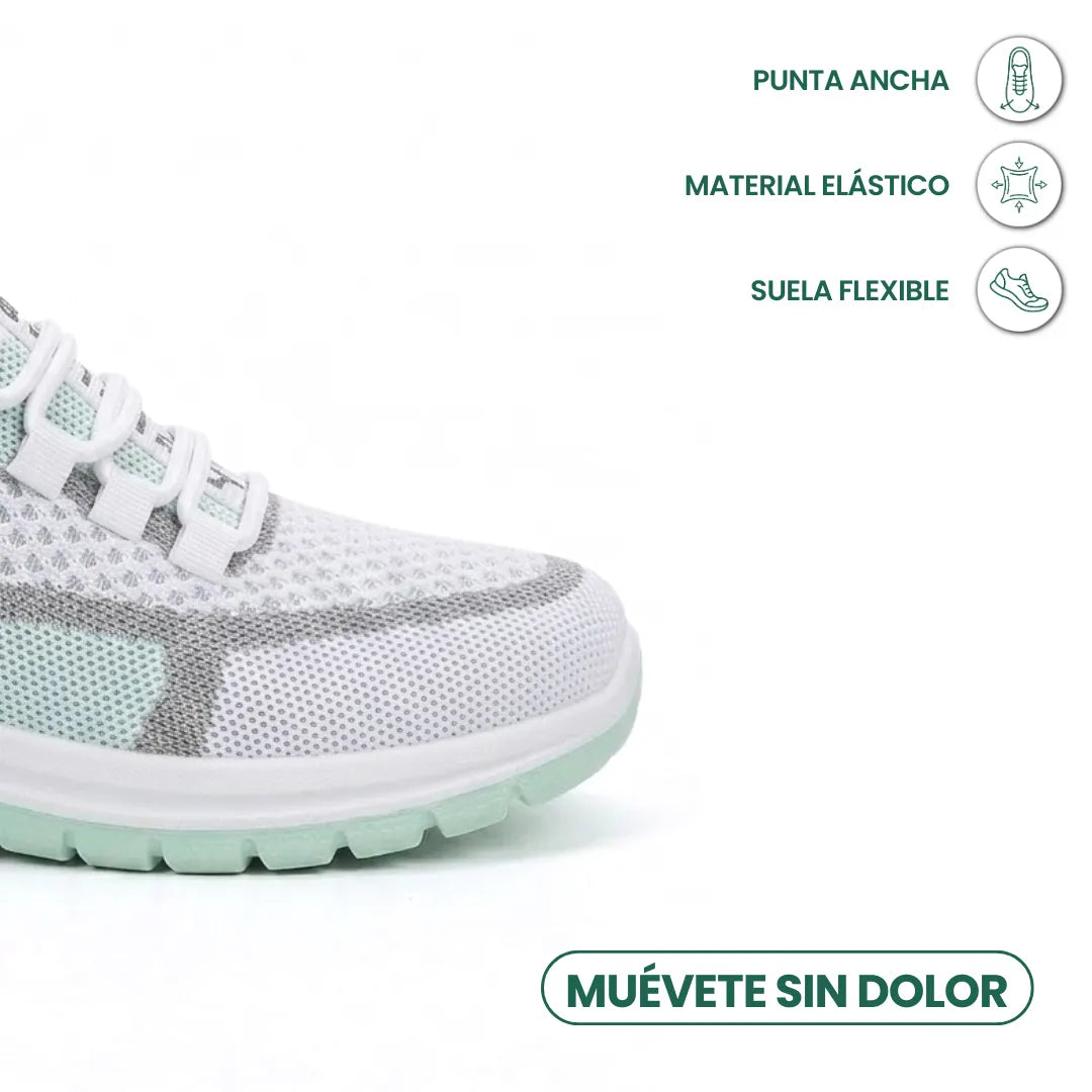 Close-up van de brede neus van de witte sneaker met mintgroene zool en pictogrammen voor ruime neus, elastisch materiaal en flexibele zool. 14