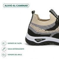 Achterkant en hiel van de beige sneaker met zwart en grijs gaas, met pictogrammen voor hielsteun, antislipzool en voetboogsteun. 40