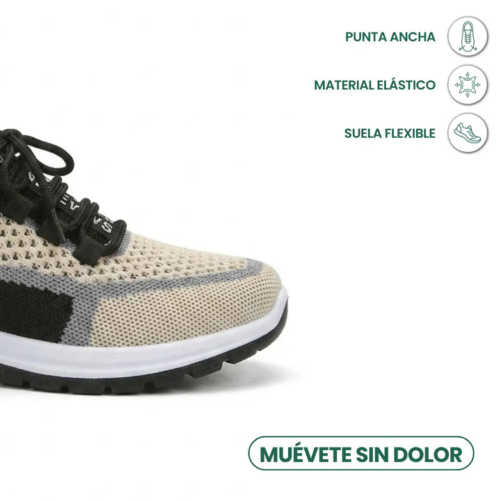 Close-up van de neus van een beige sneaker met gaas, zwarte veters en witte zool, met pictogrammen over brede neus en flexibele zool. 41
