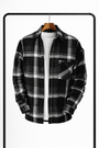 Zwart-wit geruit overhemd aan een houten hanger, open over een wit T-shirt, met borstzak en donkere knopen. 3
