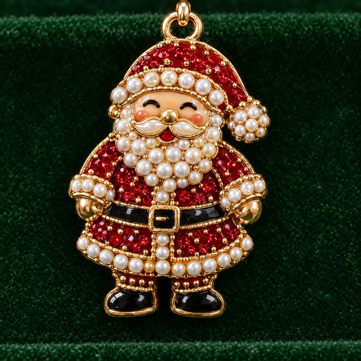 Close-up van de kerstmanbedel met rode steentjes, witte parels en gouden rand, hangend voor groen fluweel. 3