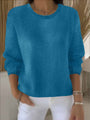 Turquoiseblauwe gebreide trui met ribboord, gedragen door een model met een witte broek 12