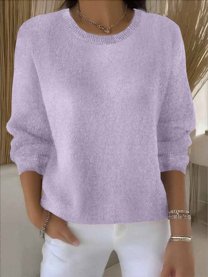 Lila gebreide trui met ribboord aan hals en manchetten, gedragen met een witte broek 14