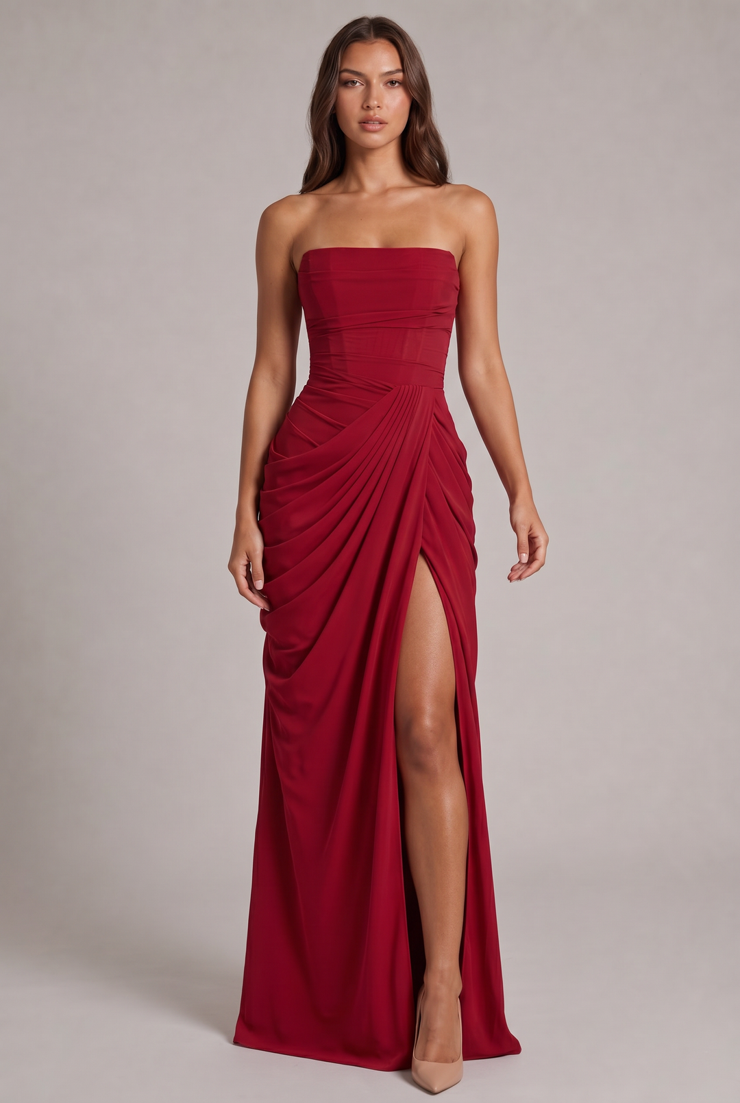 Rode strapless jurk met gedrapeerde rok en hoge split, van voren gedragen door een model 21