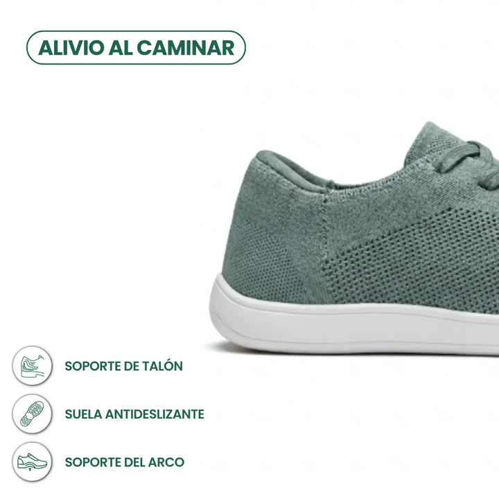 Detail van de hiel en zool van de groene gebreide sneaker met witte zool, met pictogrammen voor hielsteun en antislip. 31