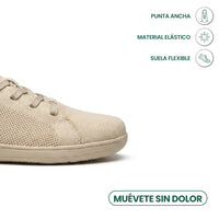 Detail van de brede neus van de beige sneaker met pictogrammen voor elastisch materiaal en een flexibele zool. 5
