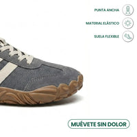 Close-up van de brede neus van de grijze schoen met pictogrammen voor ruime teenbox, elastisch materiaal en flexibele zool. 5