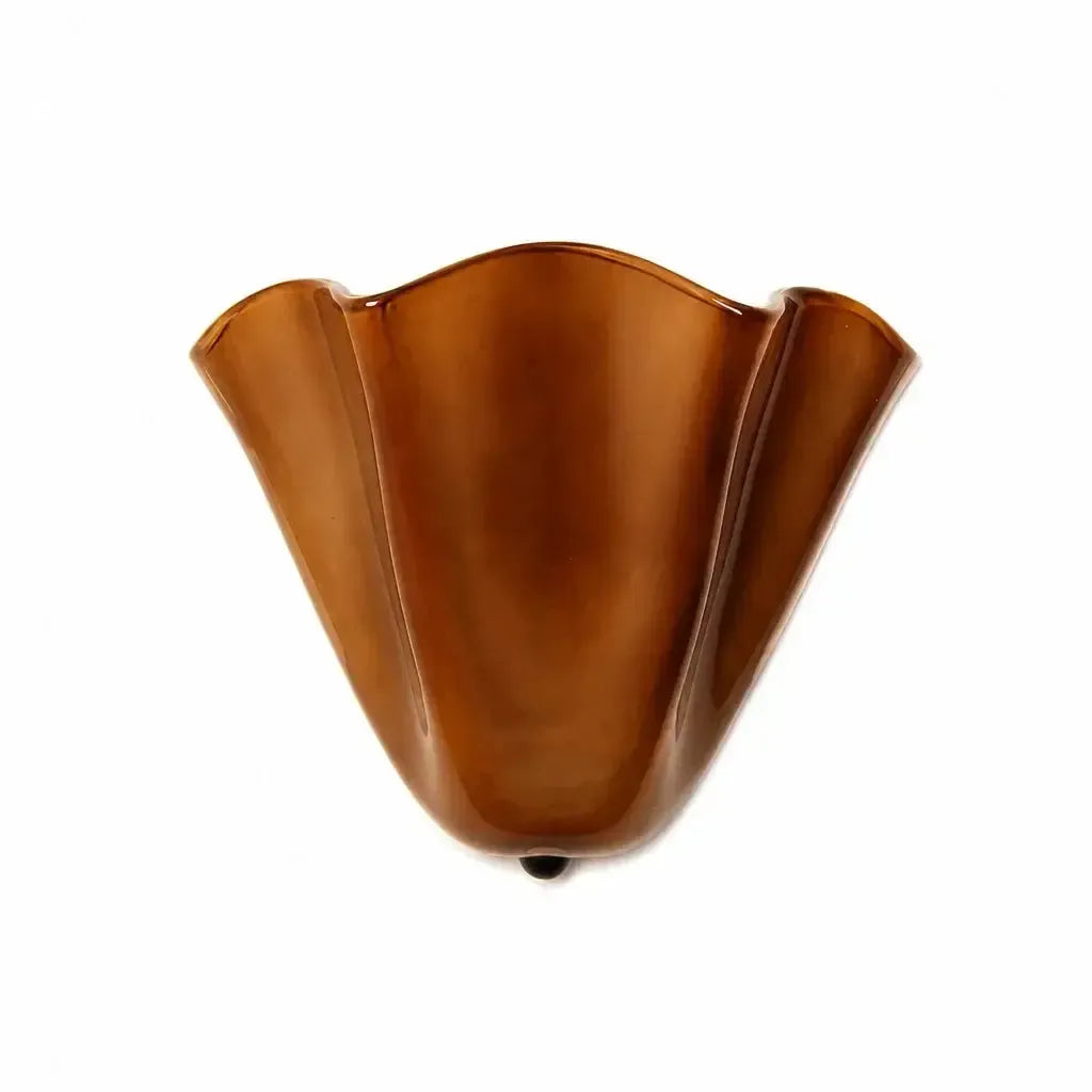 Bruine glazen wandlamp met golvende rand en klein donker knopje onderaan, vrijgesteld tegen een witte achtergrond. 12