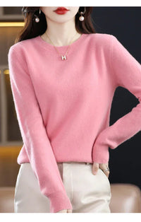 Model in een roze trui met ronde hals en ribboorden, de hand op de heup 8