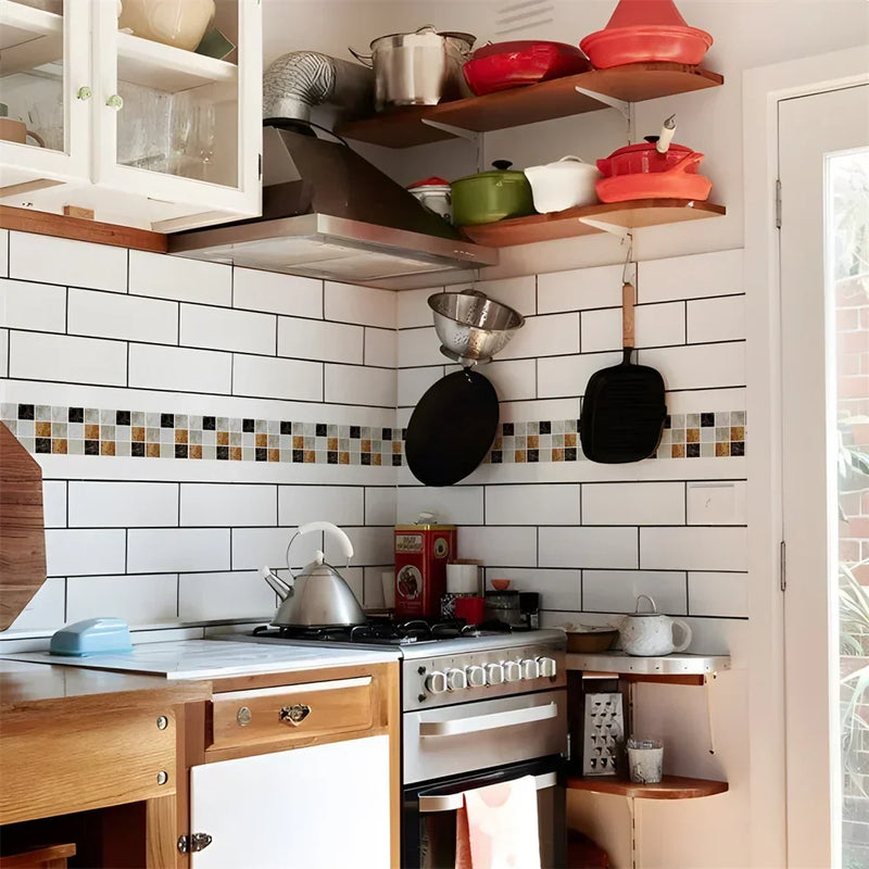 Mozaïekstrook in beige, bruin en zwart tussen witte tegels in een keuken met kookpotten 14