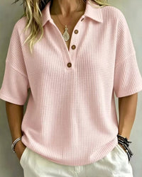 Voorkant van het lichtroze wafelpoloshirt met kraag en knoopjes, gedragen door een model 7