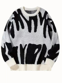 Witte gebreide sweater met zwart abstract patroon en witte ribboorden, plat van voren gefotografeerd 6