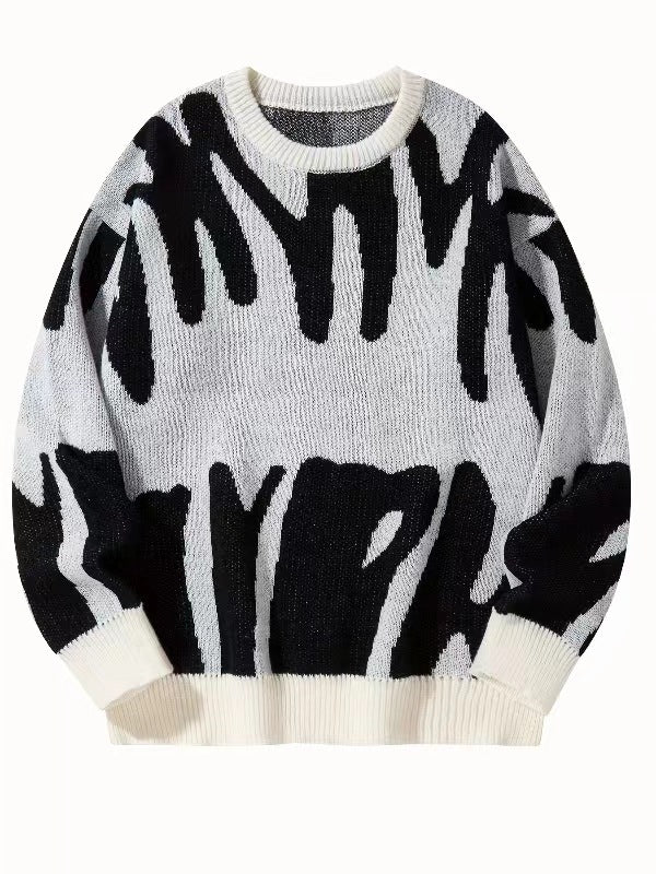 Witte gebreide sweater met zwart abstract patroon en witte ribboorden, plat van voren gefotografeerd 6