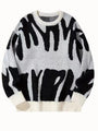 Witte gebreide sweater met zwart abstract patroon en witte ribboorden, plat van voren gefotografeerd 6