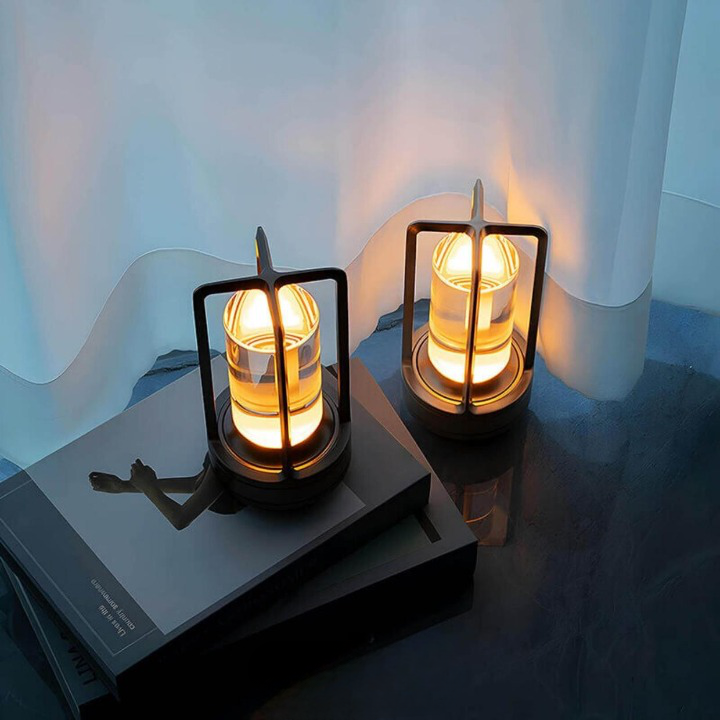 Twee brandende lampen met warm licht op gestapelde boeken voor een wit gordijn. 3