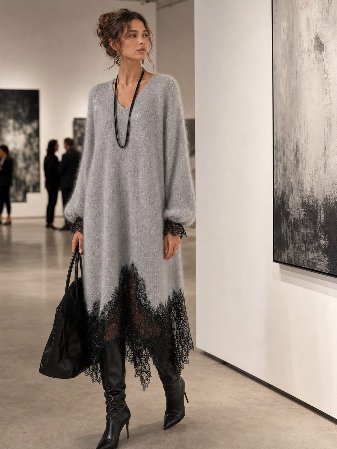Model draagt de grijze jurk met zwarte kant in een galerie, kijkend naar schilderijen 3