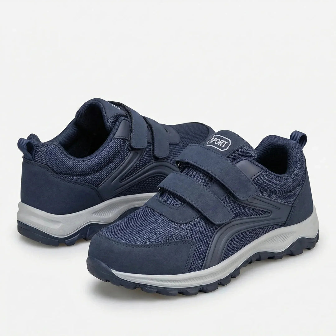 Paar blauwe klittenbandschoenen met lichtgrijze zool, een schoen schuin voor en de andere achter 9