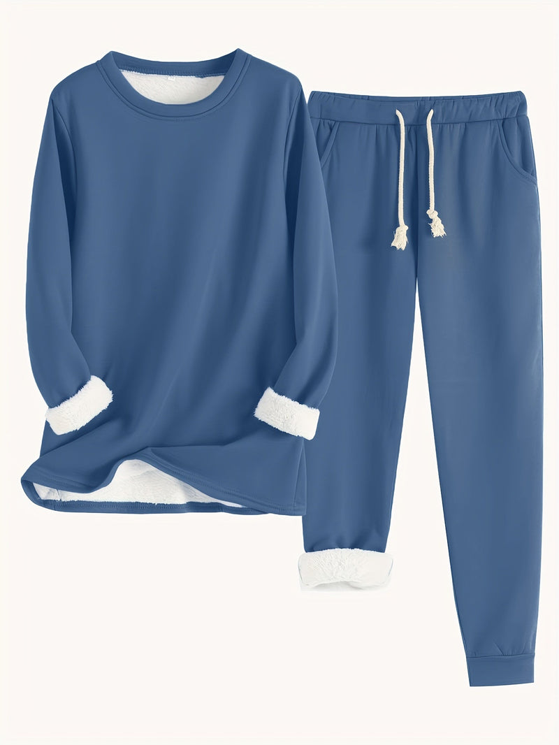 Tweedelige set in donkerblauw: trui en joggingbroek met zakken en trekkoord, witte fleecevoering aan mouwen en zoom 14