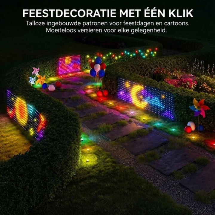 Verlichte panelen met kleurrijke motieven langs een tuinpad tussen heggen, met ballonnen en windmolentjes erbij 7
