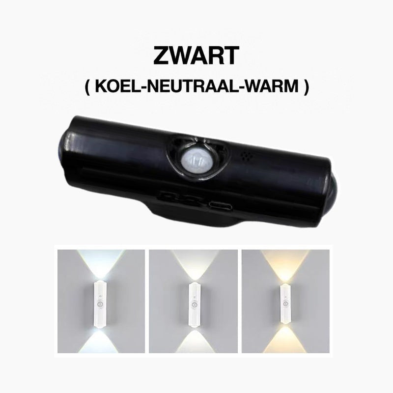 Zwarte cilindrische wandlamp met bewegingssensor, met onderaan drie witte lichtkleuren van koel tot warm op de muur 3