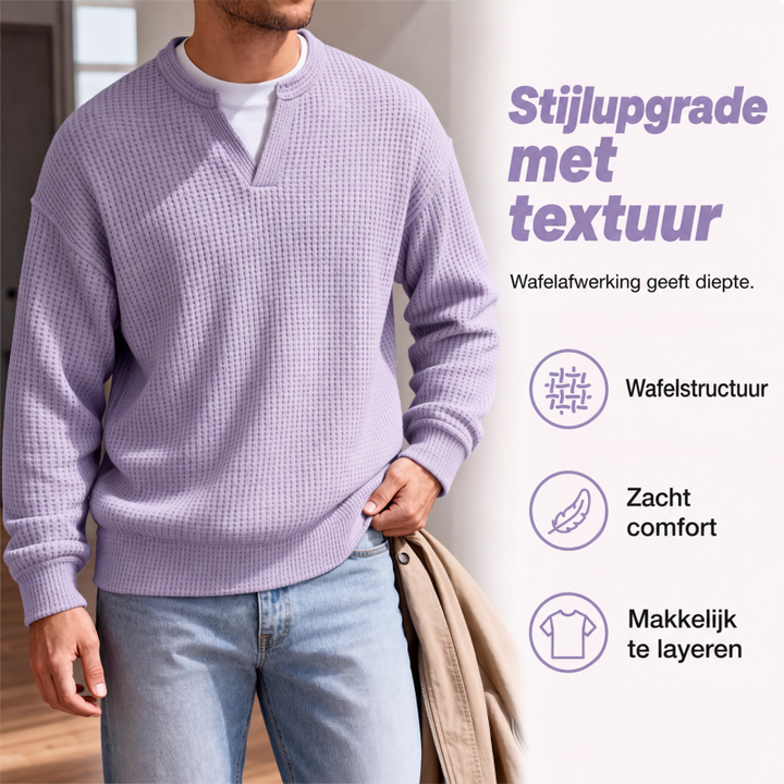 Detail van de lila wafelstructuur en V-hals op een model, met een beige jas over de hand en pictogrammen ernaast. 3