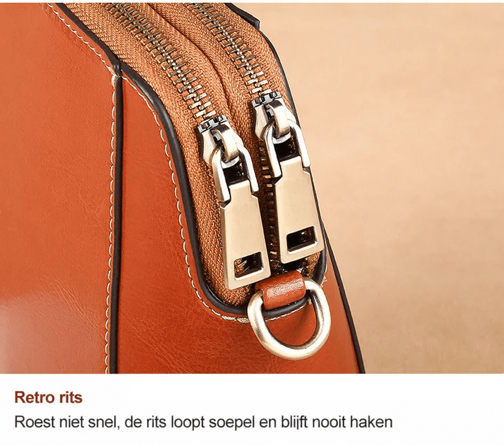 Close-up van de twee ritsen met antiek metalen trekkers en een D-ring aan de zijkant 13
