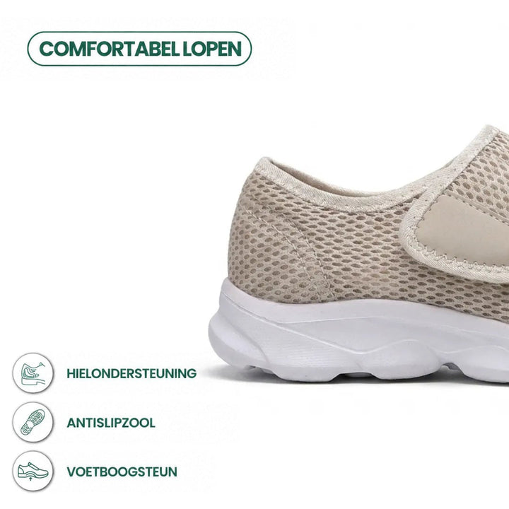 Beige mesh wandelschoen met witte zool en klittenband, detail van de hiel met pictogrammen voor hielsteun, antislipzool en voetboogsteun. 31