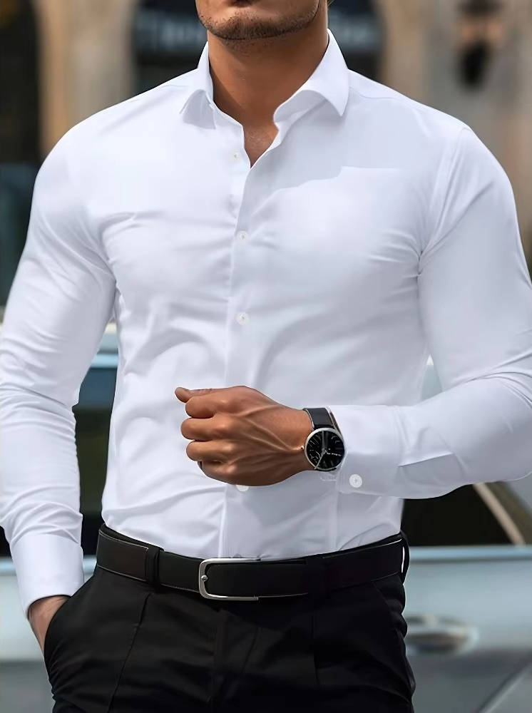 Model draagt het witte overhemd met zwarte pantalon en horloge, de hand bij de buik gebald 9
