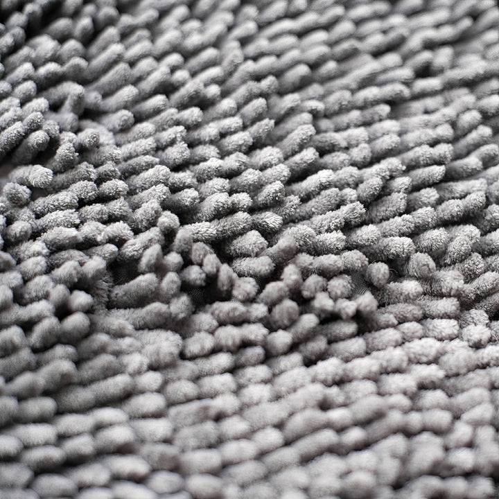 Close-up van de zachte, dicht gepakte grijze chenillevezels van de mat. 7