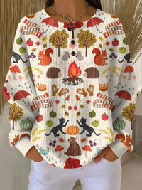 Crèmekleurige wafeltrui met knoopjes en herfstprint van egels, eekhoorns, katten, paddenstoelen en kampvuur. 19