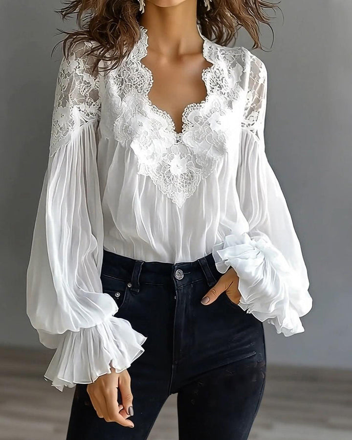 Witte blouse met kanten V-hals en geplooide ballonmouwen, een hand in de jeanszak 4