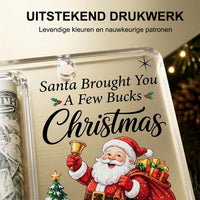 Close-up van de bedrukte voorkant met kerstman, belletje en tekst, naast het buisje met opgerold biljet. 4