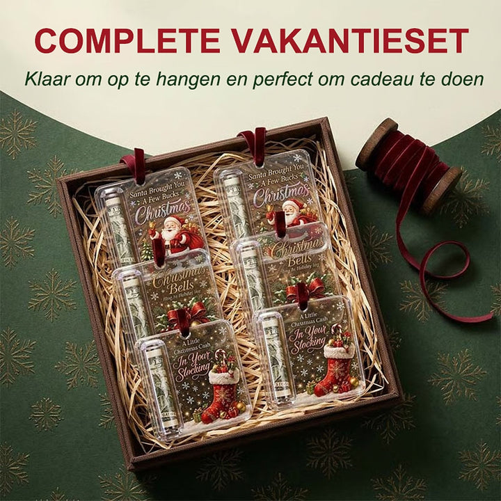 Doos met stro waarin zes hangers met verschillende kerstmotieven liggen, naast een klosje rood fluwelen lint. 7