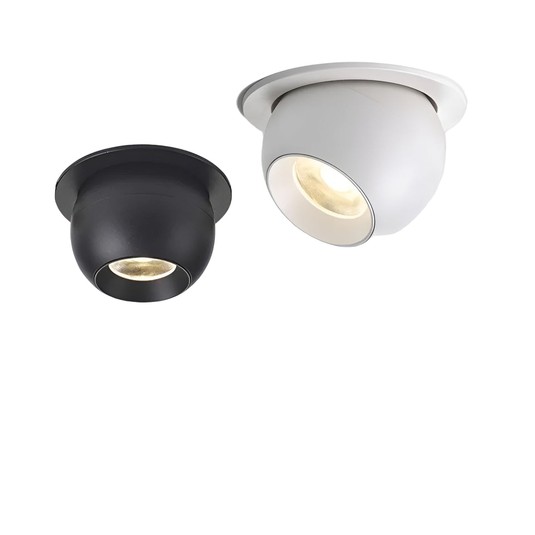 Twee ingebouwde kantelbare plafondspots, een zwarte en een witte, naast elkaar met warm licht 1