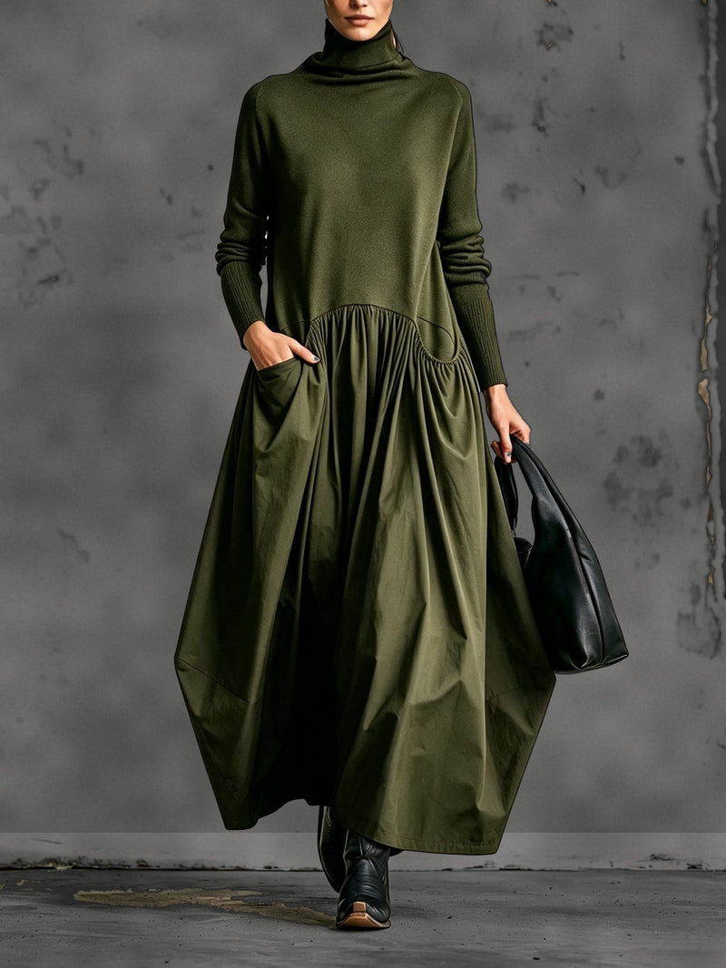Model in legergroene maxi-jurk met nepcol en gerimpelde rok, hand in de zak 4