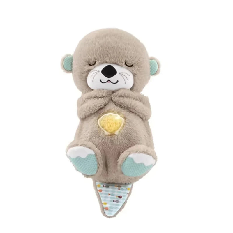 Otterknuffel met gesloten ogen op witte achtergrond, met een geel verlicht schelpje op de buik en een gestipt staartje. 17