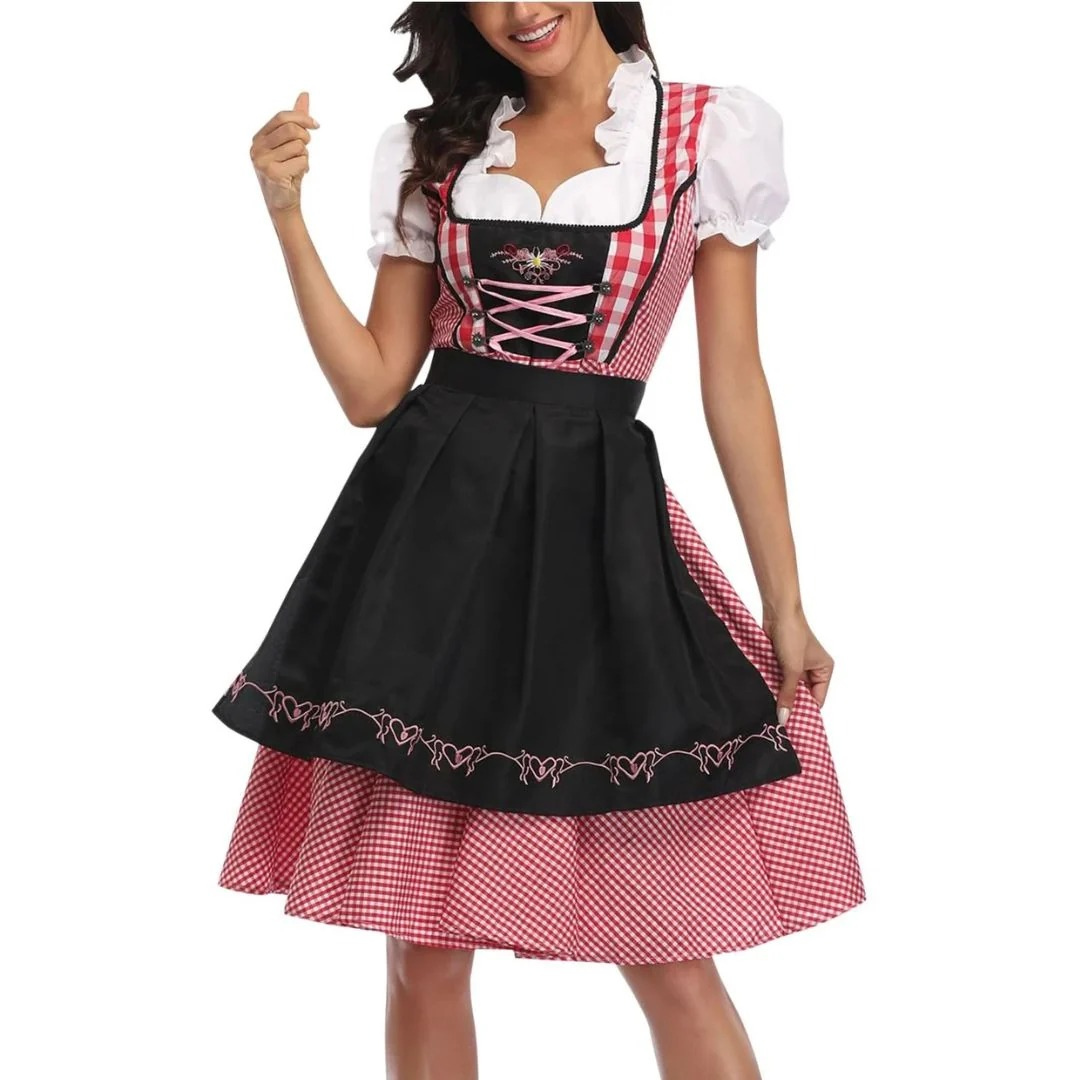 Model draagt de rood-wit geruite dirndl met zwarte schort, roze veters op het lijfje en wit blouseje met ppofmouwen, vooraanzicht. 1