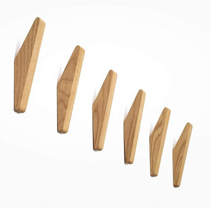 Zes houten haken in verschillende groottes diagonaal gerangschikt op een witte achtergrond, met duidelijk zichtbare houtnerf. 5