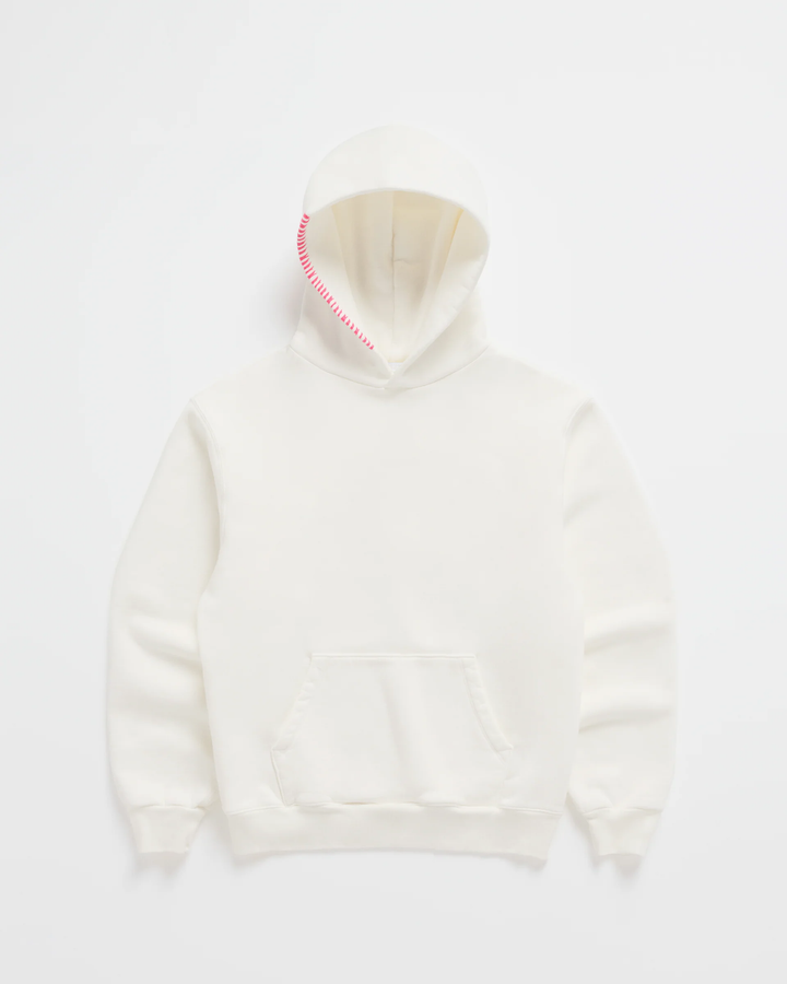 Gebroken witte hoodie van voren, met felroze stiksels langs de capuchonrand, een buidelzak en ribboorden aan mouwen en zoom. 2
