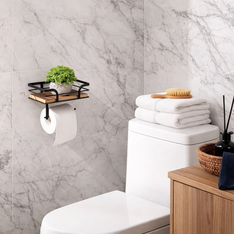Houder op een grijze marmeren wand boven een toilet, met een plantje op het plankje en een rol toiletpapier eronder. 3
